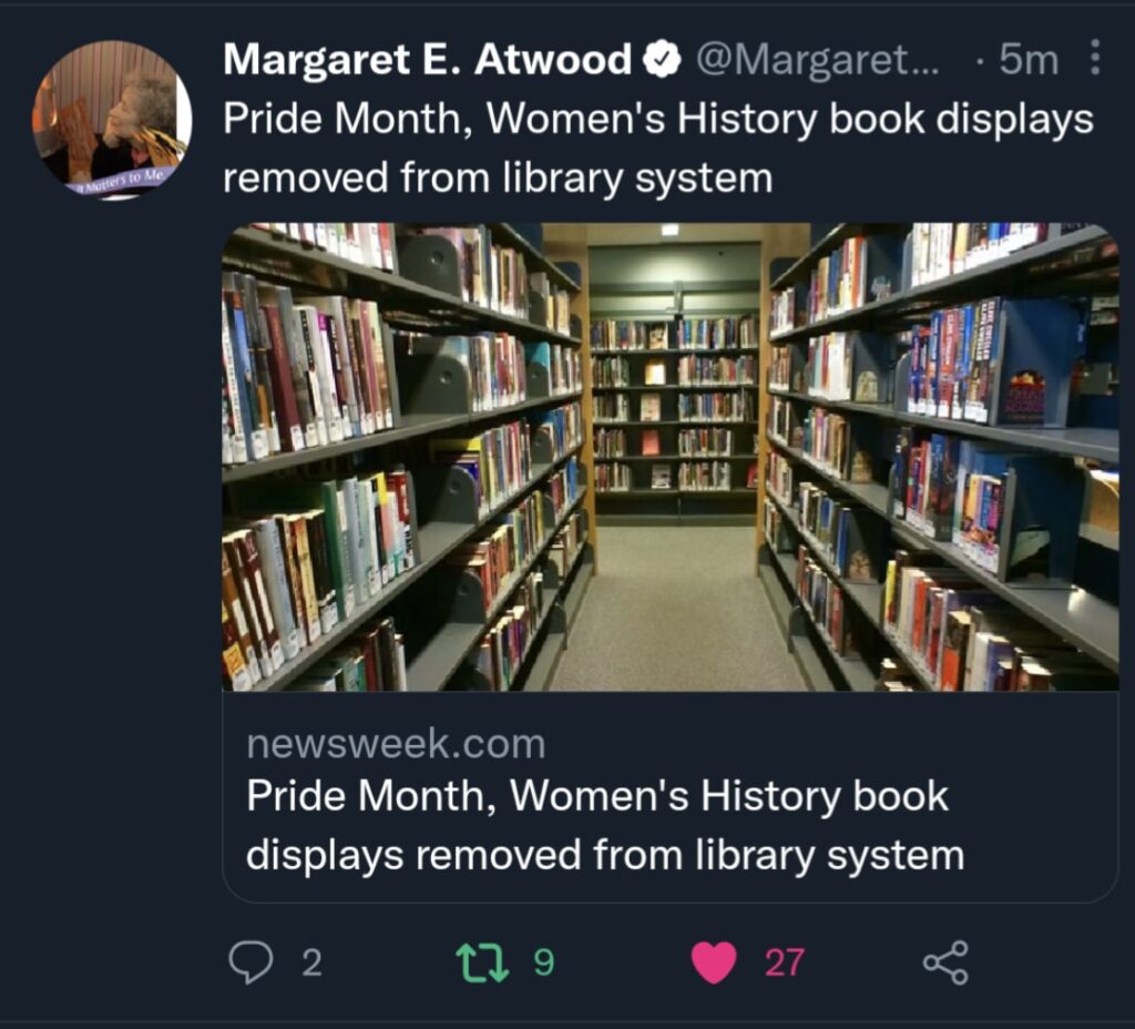 A screenshot of a tweet by Margaret Atwood. Text says "Pride month, women's history book displays removed from library system."